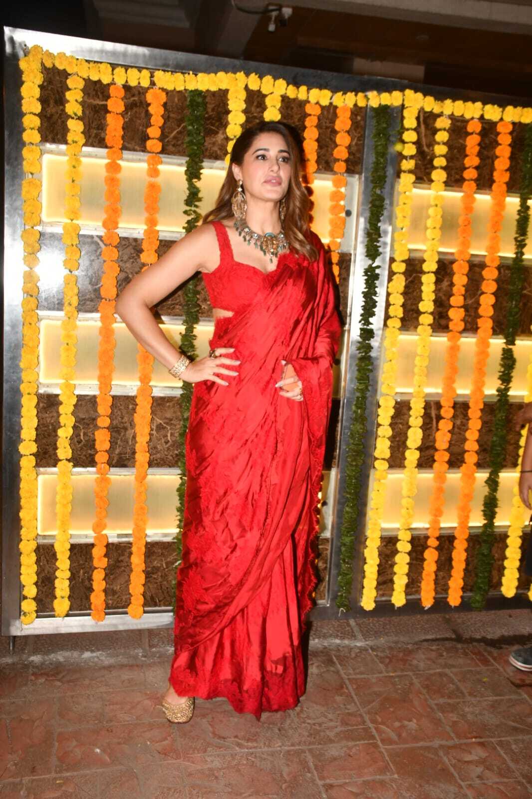 Nargis Fakhri was seen in a glamorous look as she opted for an all-red saree which she paired with sleeveless bouse and accentuated her look with heavy jewellery.